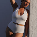 White textured halter bikini top with built-in support, flattering plunge neckline and adjustable tie-neck.