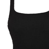 Flat lay detail of the black Azure square neck swimsuit showing its shoulder strap