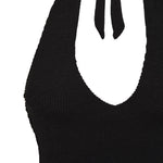 Flat lay of the black Haze swimsuit showing its halter tie and plunge V front
