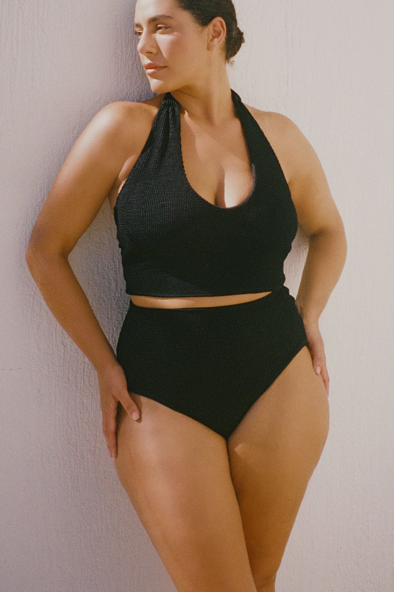 Black halter bikini top with built-in support and adjustable tie-neck.