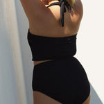 Black halter bikini top with built-in support, flattering plunge neckline and adjustable tie-neck.