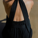 Back view of Behati Mini Dress Black showing open back and halter tie detail