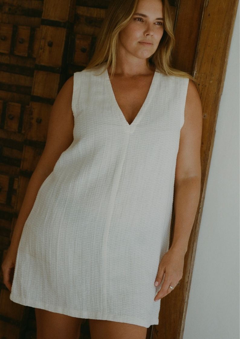 Model Bree McCann wearing Blanca Mini Dress Ecru in lightweight textured linen blend