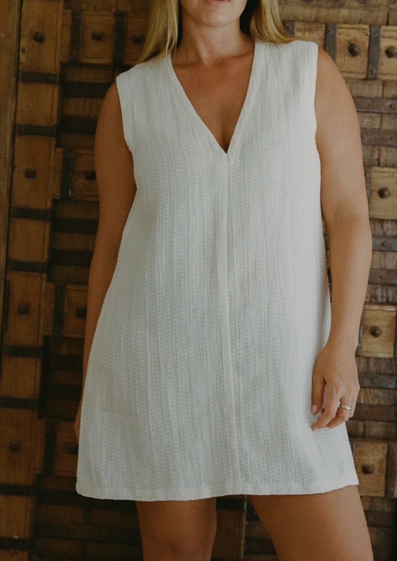 Model wearing Blanca Mini Dress Ecru in lightweight textured linen blend
