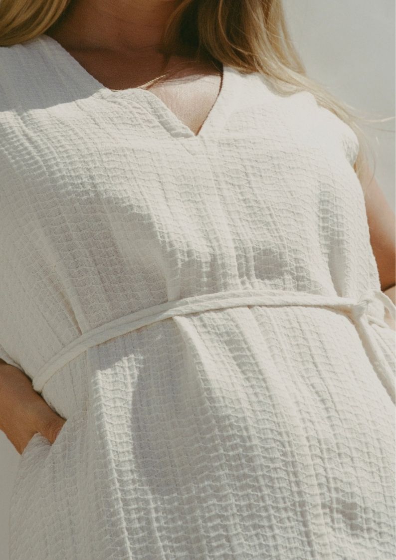 Close-up of Blanca Mini Dress Ecru textured linen waist tie detail