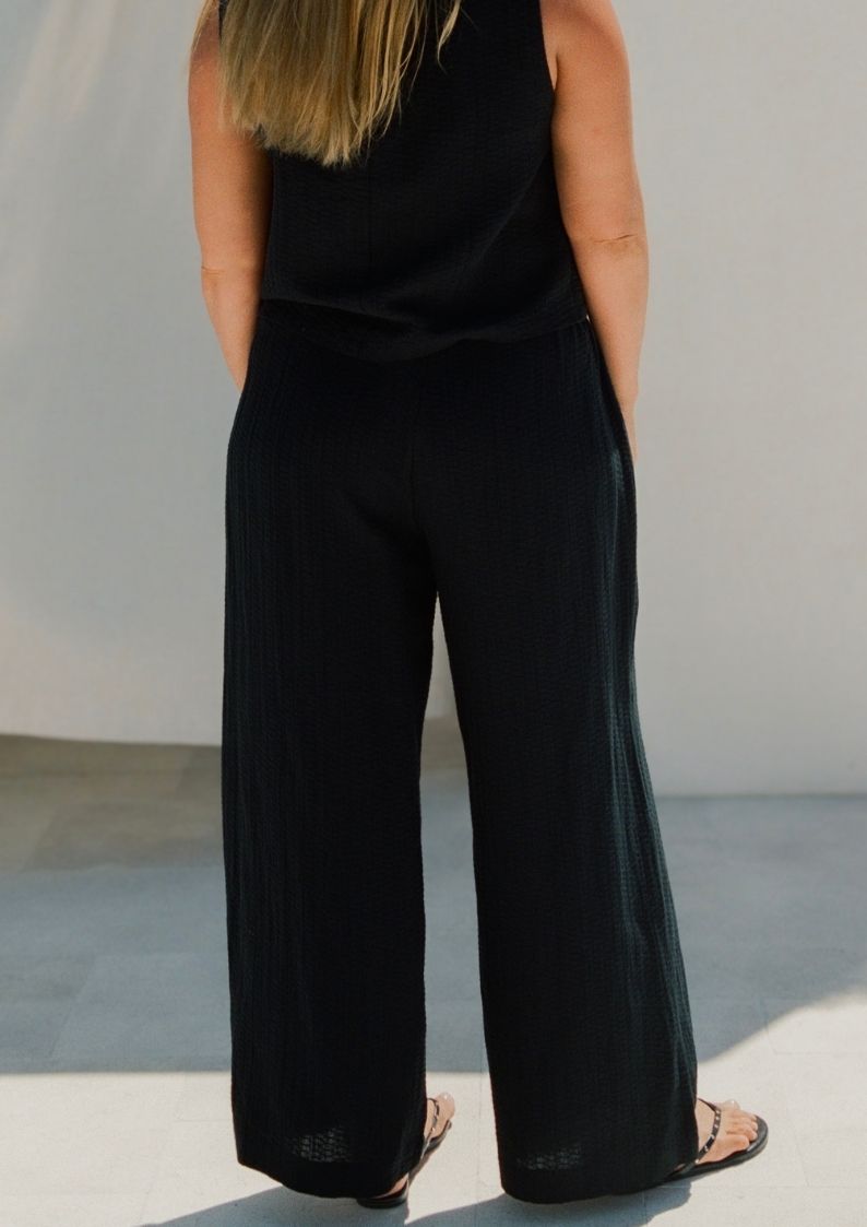 Back view of Echo Pant Black showing relaxed wide leg and elastic waistband