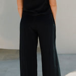 Back view of Echo Pant Black showing relaxed wide leg and elastic waistband