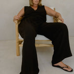 Model wearing Echo Pant Black with relaxed wide leg fit and textured linen blend