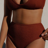 Women wearing brown rust caramel D+ bikini top and high waisted bikini bottom in textured fabric. 