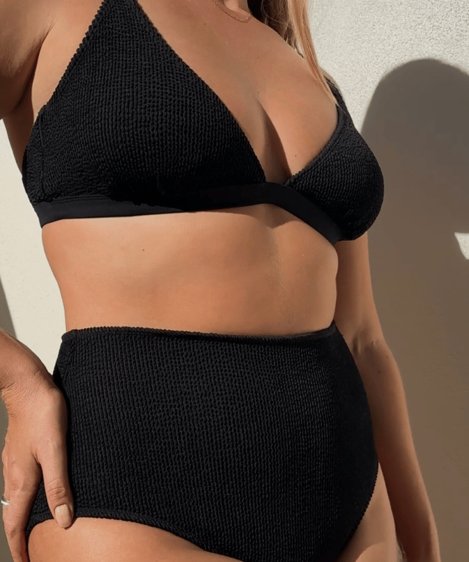 Woman wearing Bokumaia black textured triangle bikini top with supportive plunge fit and seamless shaping.