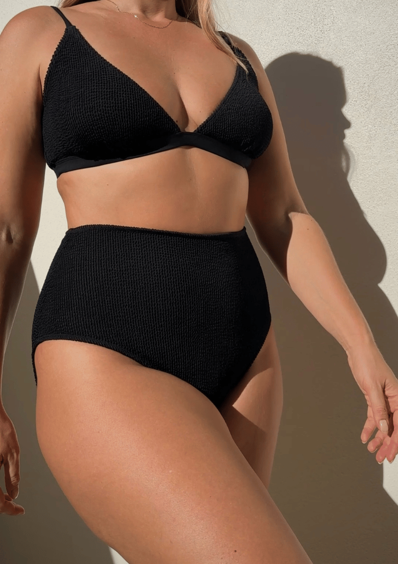 Black textured triangle bikini top styled with matching high-waisted bikini bottoms, highlighting sculpted support.